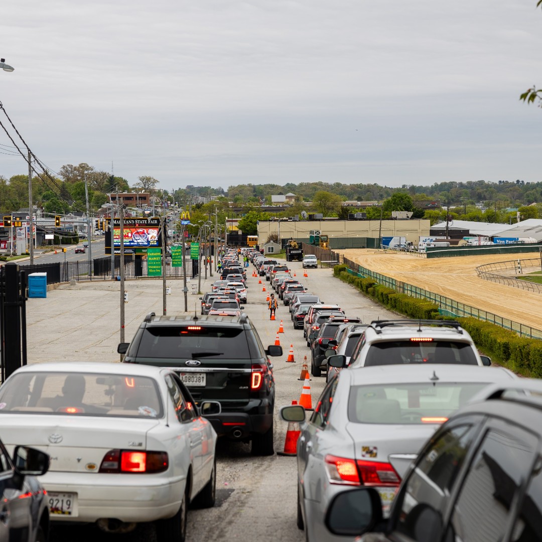 A long line of vehicles waiting for BBB Shred Day, with the shredding service ahead of them.
