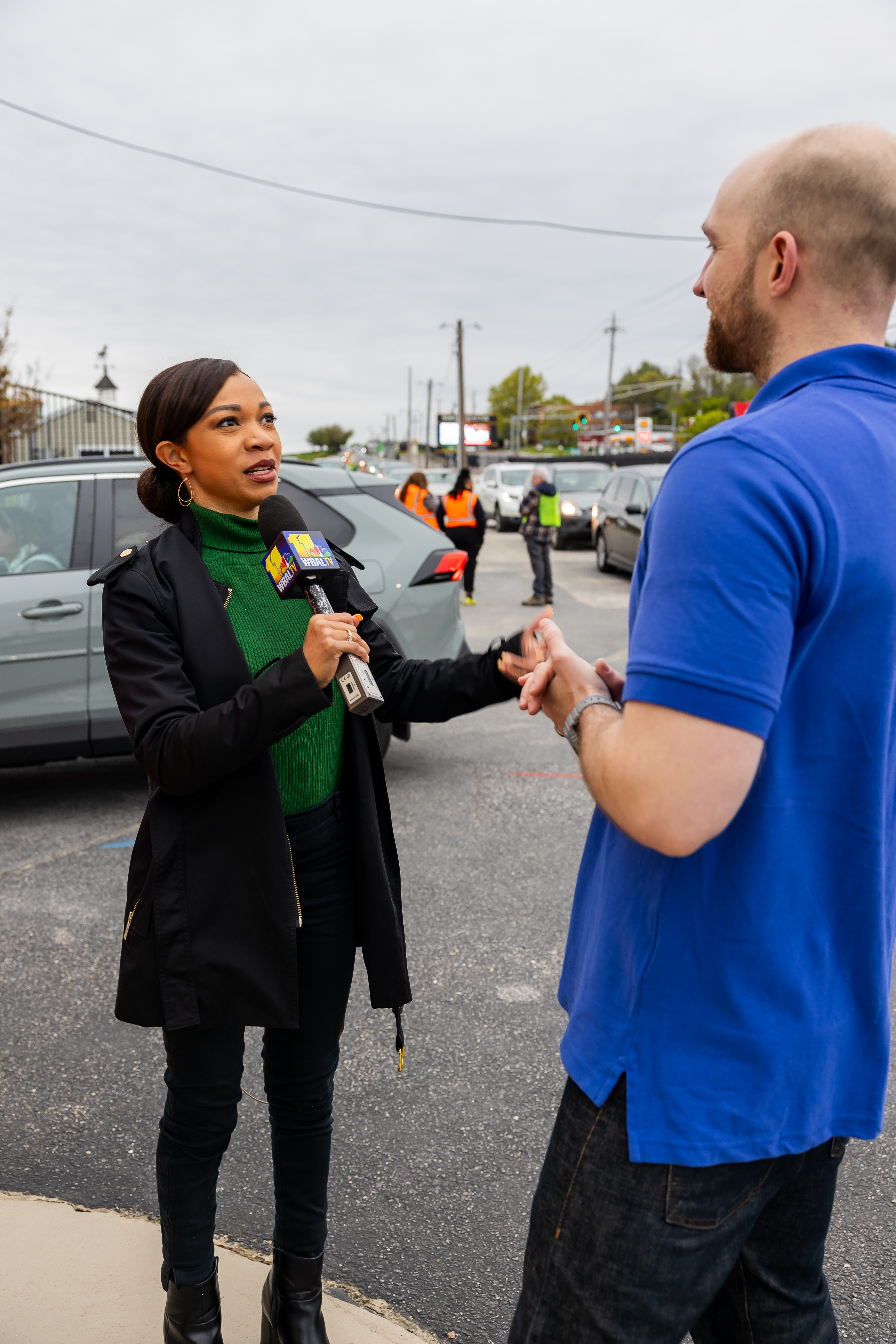 A local television crew filming on site at BBB Shred Day, with the event behind them.