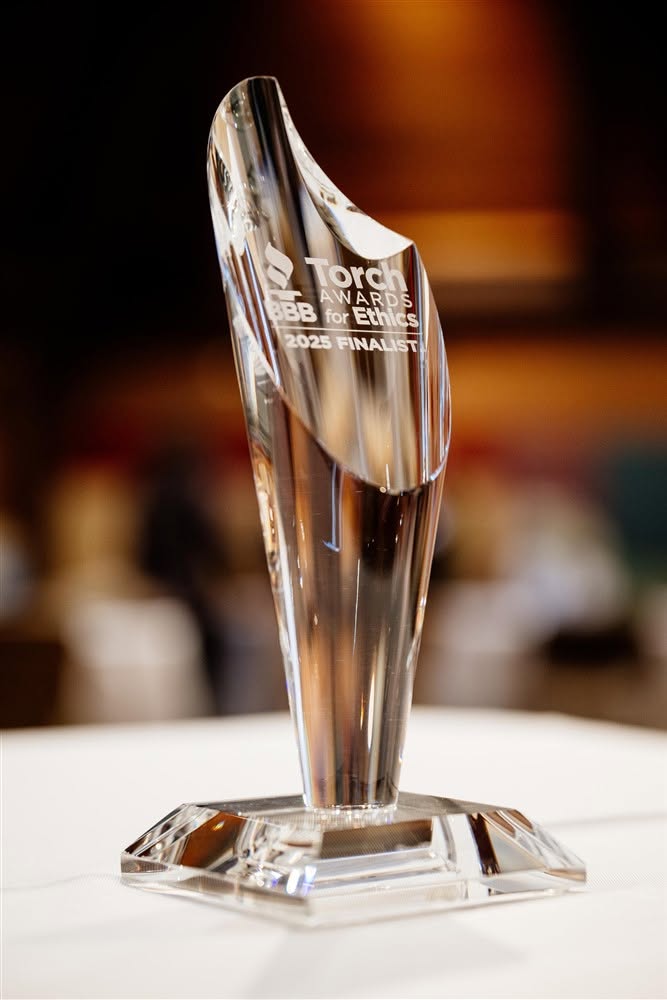 A Torch Award trophy photographed on a table at an awards event.